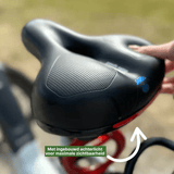 Black comfortable bicycle saddle with non-slip cover and built-in red rear light for extra visibility.