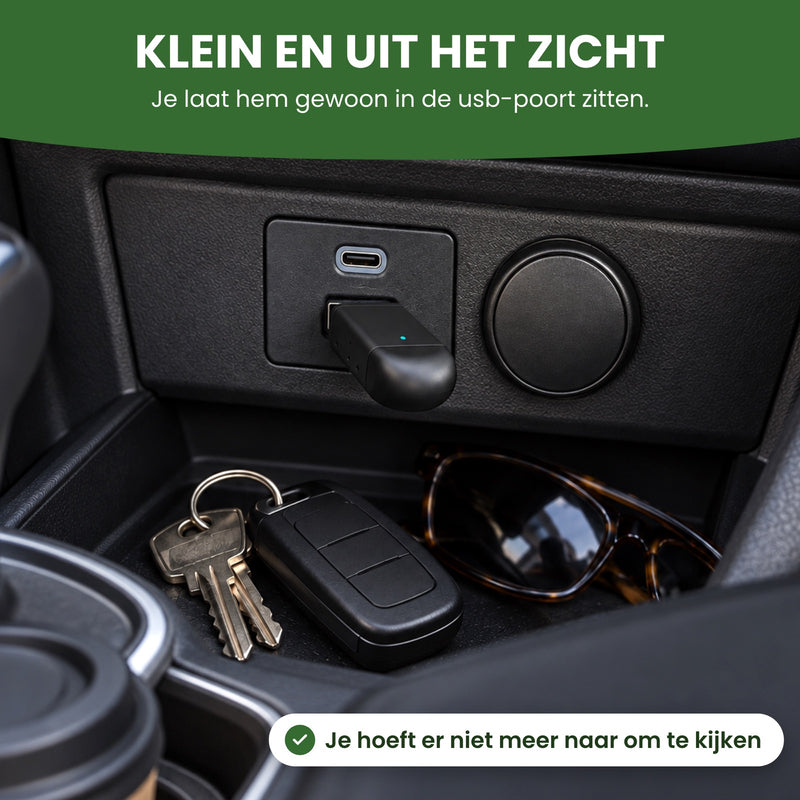 DriveLink plugged into the USB port of a center console, next to a set of keys and sunglasses: small and out of sight