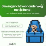 Small dog calmly sitting in a dog bed in a car while traveling