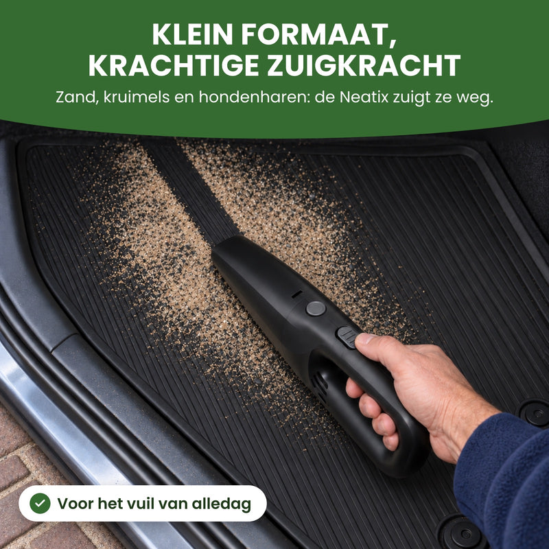 The Neatix vacuums sand off a rubber car floor mat, leaving a clean black strip: small size, strong suction