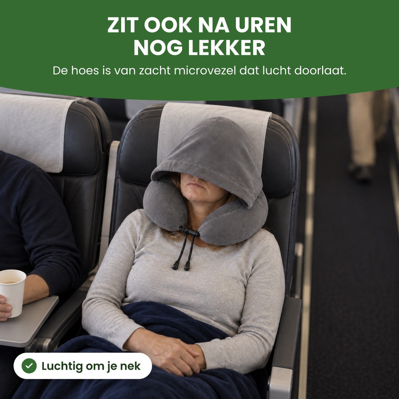 Woman in a plane aisle seat with the hood of the gray NeckEase travel pillow over her eyes and a blanket: still comfy, even hours later