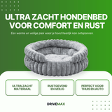 Round grey plush dog bed on green promotional background with text about ultra soft dog bed.