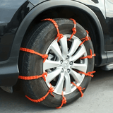 Oranje SnowGrip snow chains mounted on a car tire provide extra grip during winter conditions.