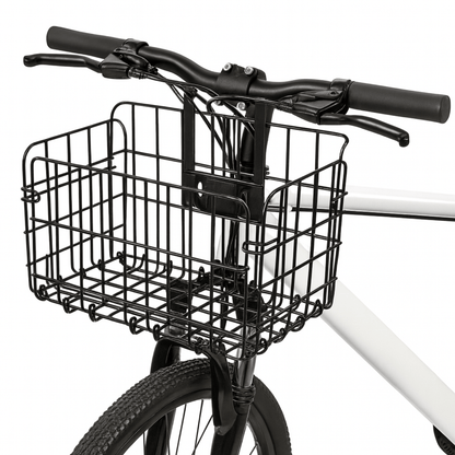 Zwarte opvouwbare metalen fietsmand van Trego bevestigd aan het stuur van een fiets, vooraanzicht.